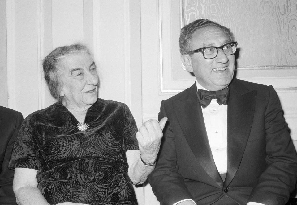 FILE - Former U.S. Secretary of State Henry Kissinger and former Israeli Prime Minister Golda Meir chat after an American Jewish Congress Dinner, Sunday night Nov. 4, 1977, in New York. Henry Kissinger's legacy in the Mideast is the pursuit of what's possible, not necessarily peace, in one of the world's most intractable conflicts. The former U.S. secretary of state, who died this week at age 100, did just that after Egypt and Syria pulled of a surprise invasion of Israel 50 years ago. (AP Photo/Ira Schwarz, File)