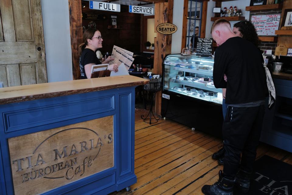 Owner Jessica Arruda greets customers at Tia Maria's European Cafe in New Bedford.