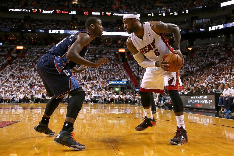 LeBron James (R) of the Miami Heat and Michael Kidd-Gilchrist of the Charlotte Bobcats during Game Two of the Eastern Conference Quarterfinals at AmericanAirlines Arena on April 23, 2014