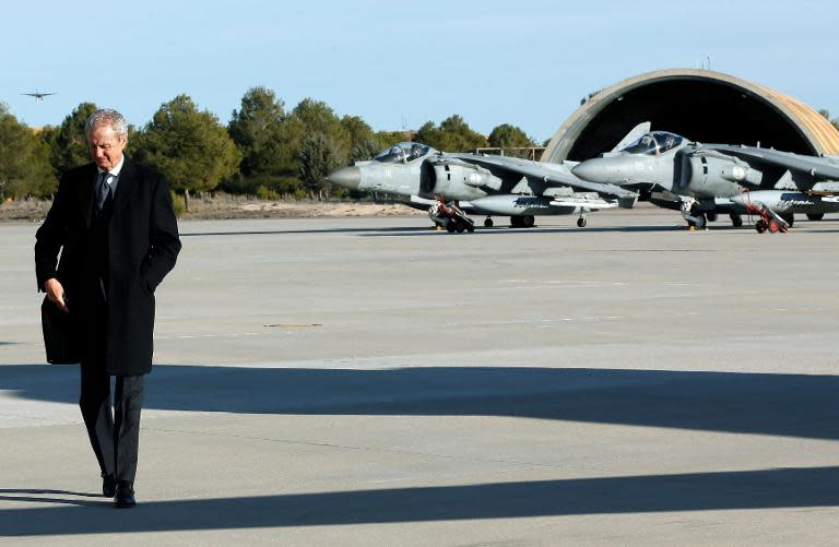 Spanish Defence Minister Pedro Morenes walks on the tarmac at Los Llanos military base in Albacete on January 27, 2015