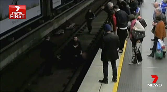 Passengers jump onto the tracks to help. Source: 7 News