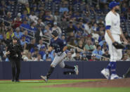 Seattle Mariners' Cal Raleigh (29) runs the bases after hitting a two-run home run off Toronto Blue Jays pitcher Tim Mayza, right, during the 10th inning of a baseball game Wednesday, April 10, 2024, in Toronto. (Nathan Denette/The Canadian Press via AP)