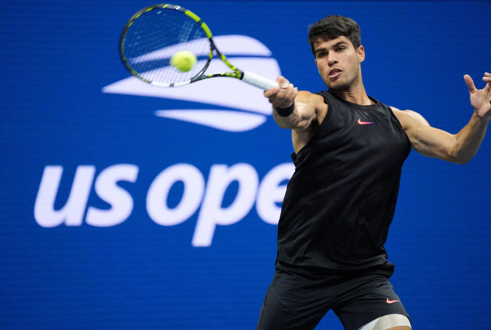 Aug 27, 2024; Flushing, NY, USA; Carlos Alcaraz of Spain hits to Li Tu of Australia on day two of the 2024 U.S. Open tennis tournament at USTA Billie Jean King National Tennis Center. Mandatory Credit: Robert Deutsch-USA TODAY Sports