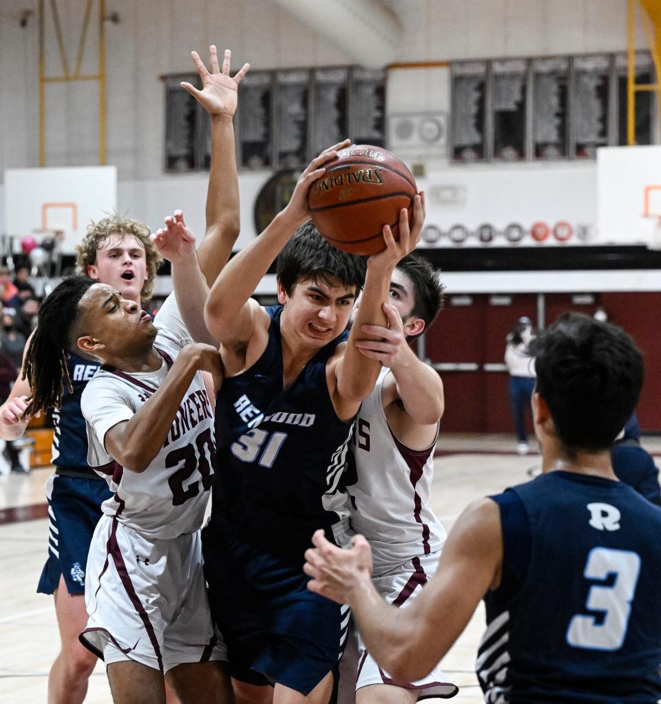 Redwood's Cole Gilcrest passes to Nahir Karimi in a West Yosemite League high school boys basketball game on Tuesday, January 25, 2022. 