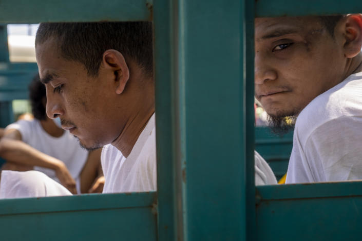 Men who were detained under the ongoing "state of exception" are transported in a cargo truck to a detention center, in Soyapango, El Salvador, Wednesday, Oct. 12, 2022. Defendants arrested under the state of exception have virtually no hope of getting individual attention from judges who hold hearings for as many as 300 defendants at a time. (AP Photo/Moises Castillo)
