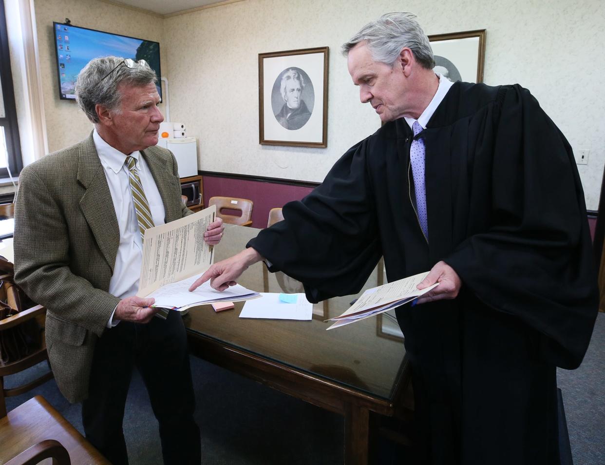 Attorney Bill Dowling and Barberton Municipal Judge Todd McKenney confer as they get ready to see a motorist who needs help getting their driver's license back in Barberton.