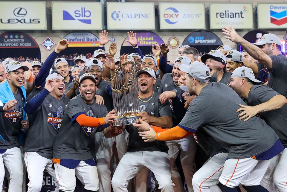 The Houston Astros celebrate with the Commissioner's Trophy after defeating the Philadelphia Phillies in six games to win the 2022 World Series title.