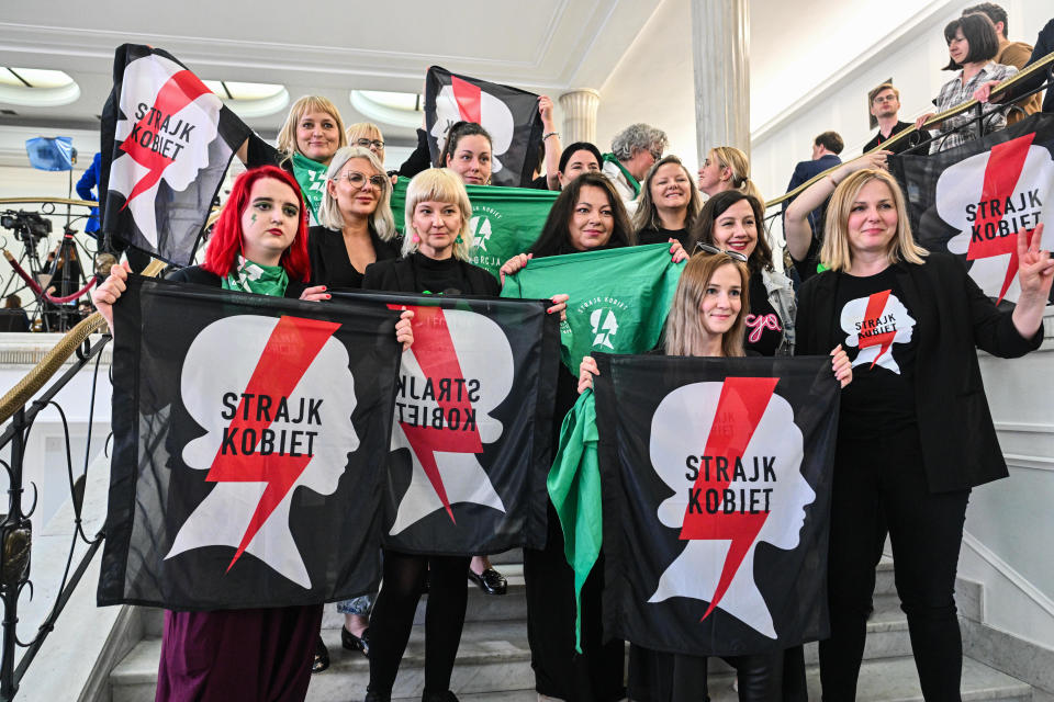 Abortion rights supporters hold the All Women's Strike flag as they celebrate after watching Poland's Parliament vote on four draft proposals to amend abortion laws in the country, April 12, 2024, in Warsaw, Poland. / Credit: Omar Marques/Getty Images