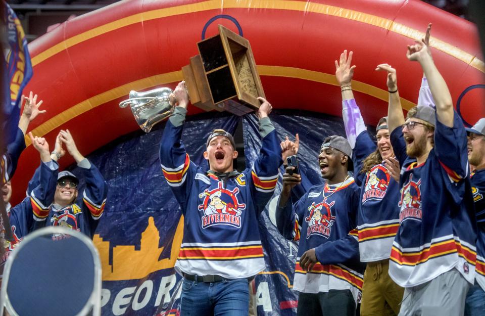 Peoria Rivermen captain Alec Hagaman of Dunlap raises the SPHL President's Cup as he makes his entrance during a ceremony celebrating the team's championship Friday, May 6, 2022 at the Peoria Civic Center.