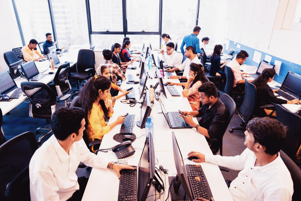 Corporate Business, Indian, Office - Group of Customer Service Executives Attending Calls at a Busy Call Centre