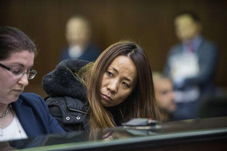 Hajoung 'Dada' Heath (C), 40, appears in criminal court in New York January 30, 2014. REUTERS/Steven Hirsch/Pool