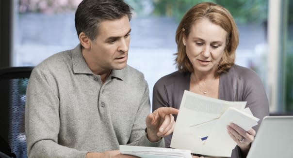 Caucasian couple paying bills online together