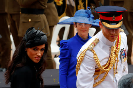 Britain's Prince Harry and Meghan, Duchess of Sussex, accompanied by Governor of New South Wales David Hurley (not pictured) and his wife Linda, stop to talk to a group of indigenous Australians as they leave the enhanced ANZAC memorial in Hyde Park, Sydney, Australia October 20, 2018. REUTERS/Rick Stevens