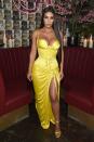 <p>In a bright yellow silk vintage Versace gown from Spring 1995 collection with matching yellow heels at NYC's Business of Fashion dinner.</p>