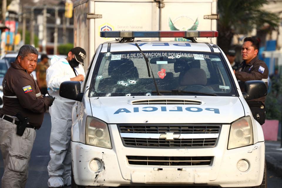 National police officers work at the crime scene of an attack on a patrol car where two policemen were killed in the Maria Piedad neighbourhood in Duran, Ecuador, on November 1, 2022.  / Credit: GERARDO MENOSCAL/AFP via Getty Images