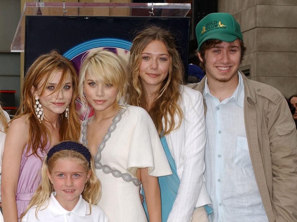 Mary-Kate Olsen and Ashley Olsen with half-sister (front), sister Elizabeth and brother James "Trent" in 2004.