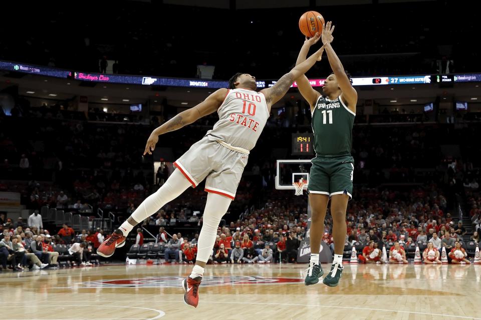 Michigan State's A.J. Hoggard shoots the ball over the defense of Ohio State's Brice Sensabaugh during the second half at the Jerome Schottenstein Center on Feb. 12, 2023 in Columbus, Ohio. Michigan State defeated Ohio State 62-41.