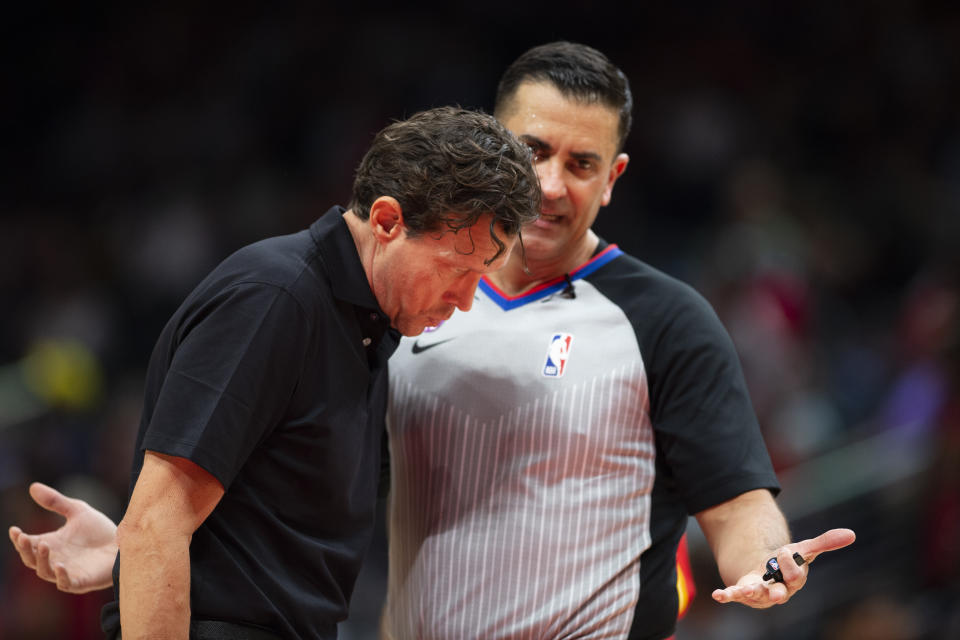 Referee Zach Zarba speaks to Atlanta Hawks head coach Quin Snyder during the first half of an NBA basketball game against the Indiana Pacers, Saturday, March 25, 2023, in Atlanta. (AP Photo/Hakim Wright Sr.)
