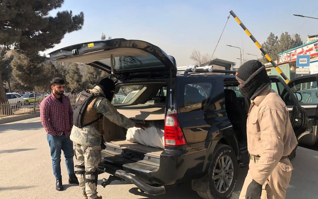 Afghan security officials check vehicles at a checkpoint in Kabul, Afghanistan - Shutterstock /Shutterstock 