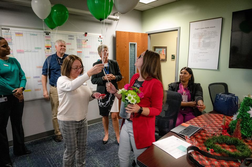 Flagler Schools Chief Financial Officer Patty Wormeck gives Bunnell Elementary School Assistant Principal Donelle Evensen balloons on Monday, Nov. 28, 2022, after receiving the district's Assistant Principal of the Year award.