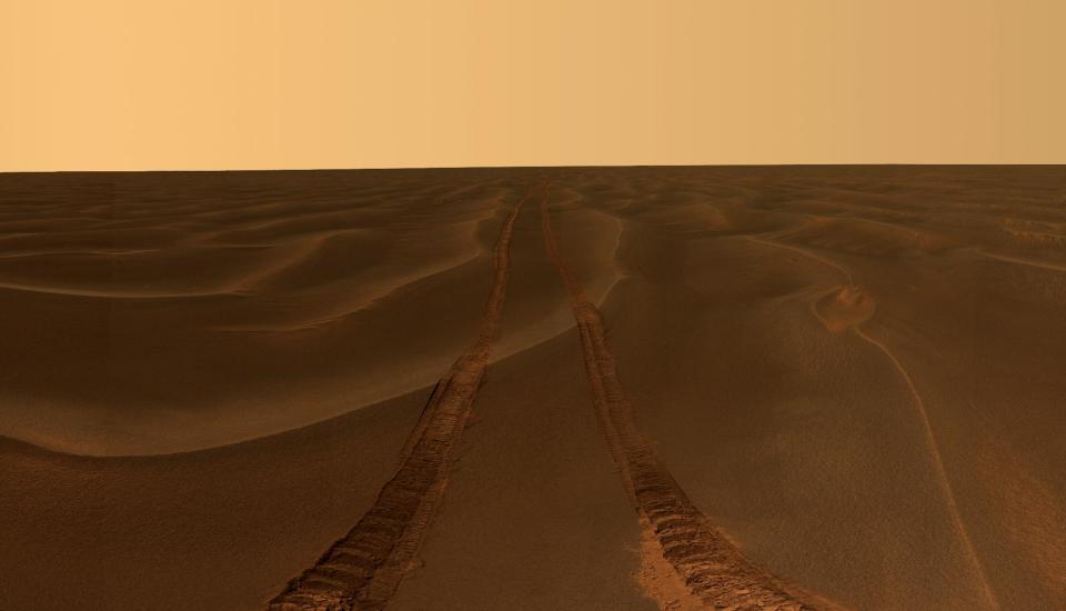 This image provided by NASA, shows rover tracks disappearing toward the horizon in a sea of sand between the craters Endurance and Victoria on the Meridiani Plains. Mars rover Opportunity took the image while stuck in the sand ripple dubbed Purgatory for over a month. Ten years after NASA landed two rovers on Mars on a 90-day mission, one rover is still exploring, and the project has generated hundreds of thousands of images from the Martian surface. Now the Smithsonian’s National Air and Space Museum is presenting more than 50 of the best photographs from the two Mars rovers in an art exhibit curated by the scientists who have led the ongoing mission. (AP Photo/NASA/JPL-Caltech/Cornell University)