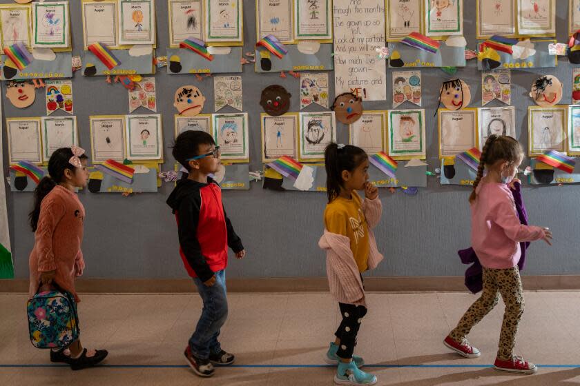 POMONA, CA - MAY 02: Pomona Unified is ahead of the state on its transitional kindergarten expansion and is planning to open the program to all 4 year-olds next year - one year ahead of the state's timeline. In a unique approach to staffing challenges, Pomona schools like Vejar Elementary have relied on dividing their transitional kindergarten class into two half day programs that overlap for a few hours in between, which means an aide is only necessary during a small period of the day. However, as transitional kindergarten expands next year to include additional 4-year-olds, schools in Pomona will move from a half day to a full day program and more classes will be added. Kindergarteners on their way to lunch class at Vejar Elementary School on Tuesday, May 2, 2023 in Pomona, CA. (Irfan Khan / Los Angeles Times)