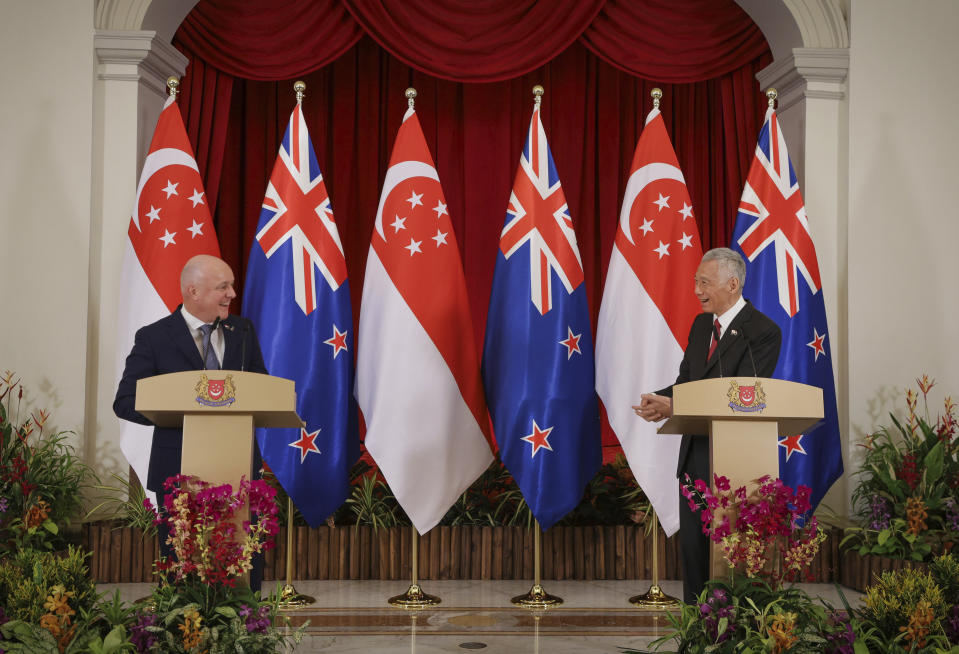 In this photo released by Singapore's Ministry of Communications and Information, New Zealand Prime Minister Luxon, left, chats with Singapore's Prime Minister Lee Hsien Loong during a news conference at the Istana, Monday, April 15, 2024. (Terence Tan/Ministry of Communications and Information via AP)