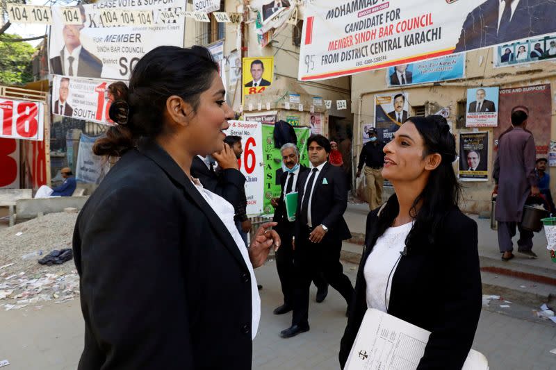 Nisha Rao, 28, a transgender woman who became country's first practicing lawyer, shares a moment with her colleague at the district City Court in Karachi,