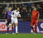 Swansea City's Michu (C) celebrates scoring a goal against Liverpool's goalkeeper Simone Mignolet (L) and Martin Skrtel during their English Premier League soccer match at the Liberty Stadium in Swansea, Wales September 16, 2013.