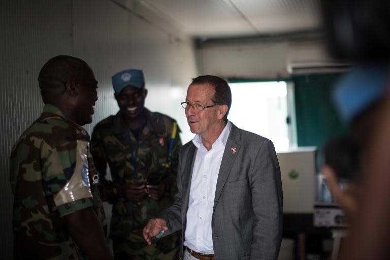 Martin Kobler (C), head of the United Nations Organization Stabilization Mission in the Democratic Republic of Congo, speaks with soldiers in Kinshasa on April 19, 2015