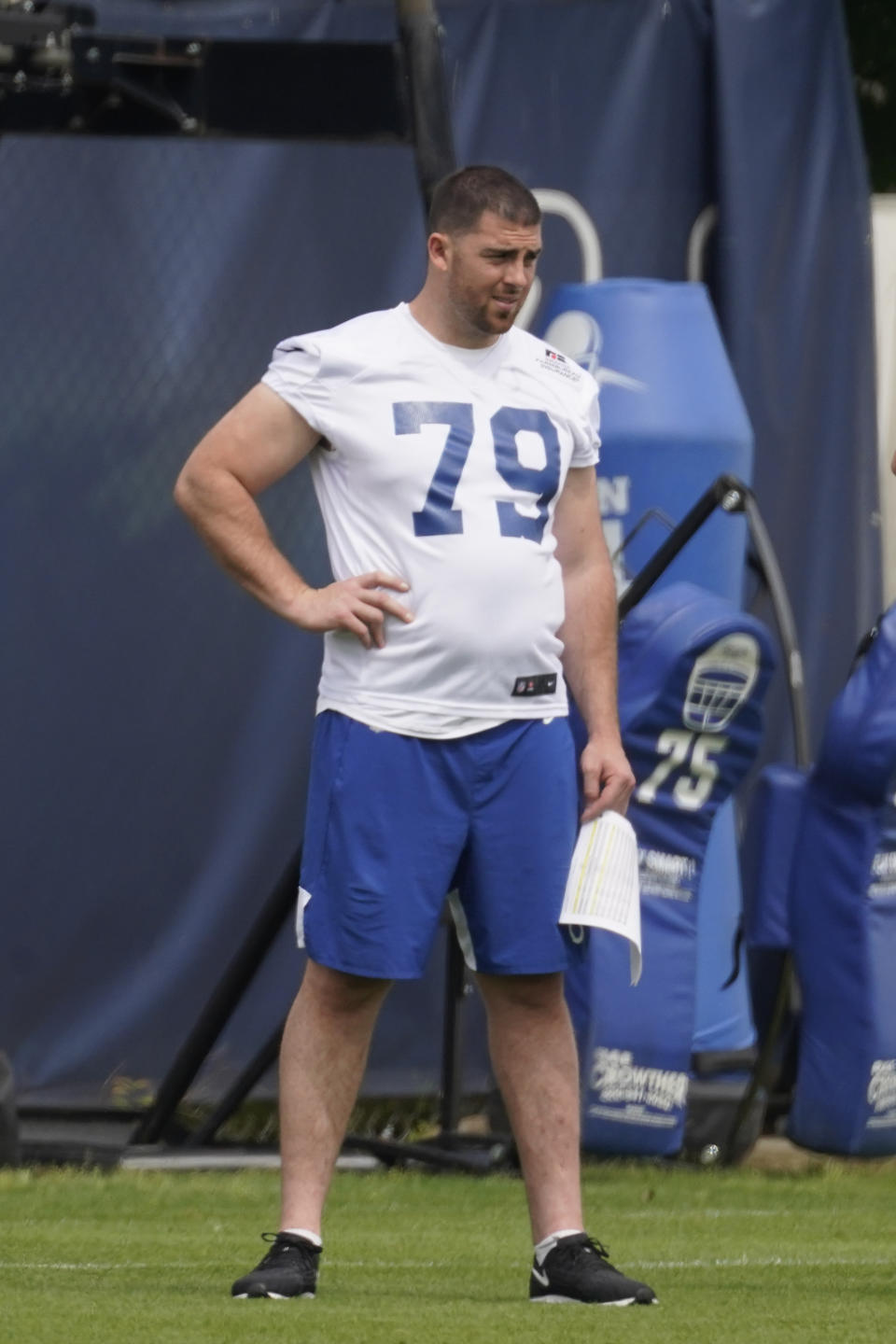 FILE - In this May 27, 2021, file photo, Indianapolis Colts' Eric Fisher watches during NFL football practice in Indianapolis. After eight seasons in Kansas City, he was released in March as a cost-cutting move and spent the next two months uncertain about his future. In May, he finally signed with the Indianapolis Colts. And now, following nearly eight months of rehab, the two-time Pro Bowl left tackle appears to be nearing a return.(AP Photo/Darron Cummings, File)