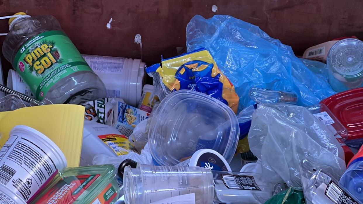 A mix of different kinds of plastic inside one of the blue bins in Yellowknife in March 2024. (Travis Burke/CBC - image credit)