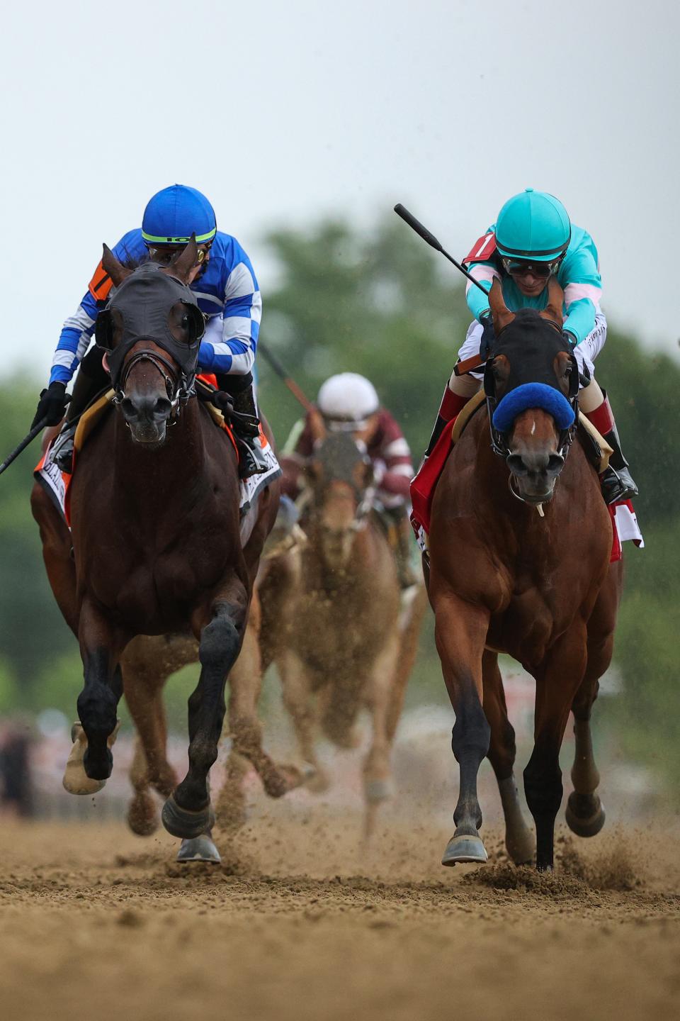 Jockey John Velazquez riding National Treasure (R) rides alongside jockey Irad Ortiz Jr. riding Blazing Sevens (L) to cross the finish line first to win the 148th Running of the Preakness Stakes at Pimlico Race Course on May 20, 2023 in Baltimore, Maryland. (Photo by Patrick Smith/Getty Images)