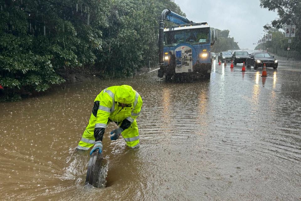 An emergency responder works in California floodwaters (AP)