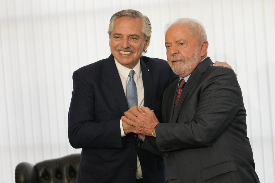 Brazilian President Luiz Inacio Lula da Silva, right, and Argentina's President Alberto Fernandez pose for photos during a bilateral meeting at Itamaraty Palace the day after Lula's inauguration in Brasilia, Brazil, Monday, Jan. 2, 2023. (AP Photo/Eraldo Peres)