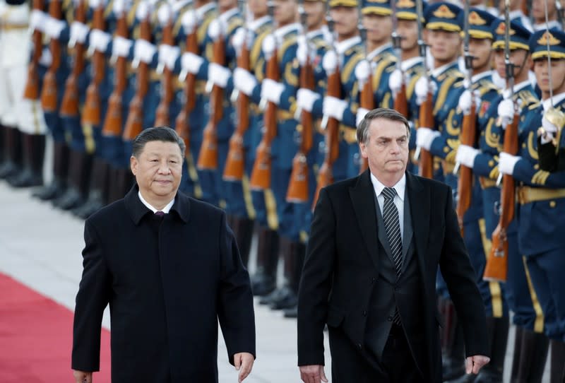 Chinese President Xi Jinping and Brazilian President Jair Bolsonaro attend a welcoming ceremony in Beijing