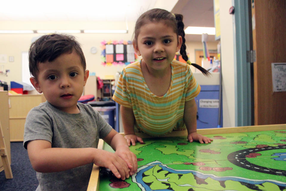 Students Arelyanna, 3, and Javier, 2, play with their toy cars to wrap up the day at Cuidando Los Ninos in Albuquerque, N.M. The charity provides housing, child care and financial counseling for mothers, all of whom will benefit from expanded Child Tax Credit payments that will start flowing in July to roughly 39 million households. (AP Photo/Susan Montoya Bryan)