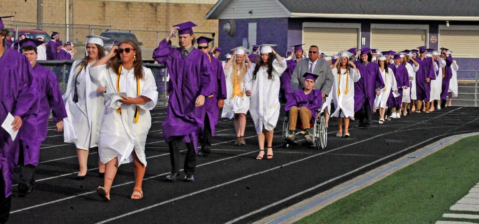 Over 100 graduating seniors walk into the Triway High School stadium Friday, May 20 for their graduation ceremony. By hosting the ceremony outside, ticket numbers were not limited and graduates could invite as many people as they wanted to which was a first since COVID.