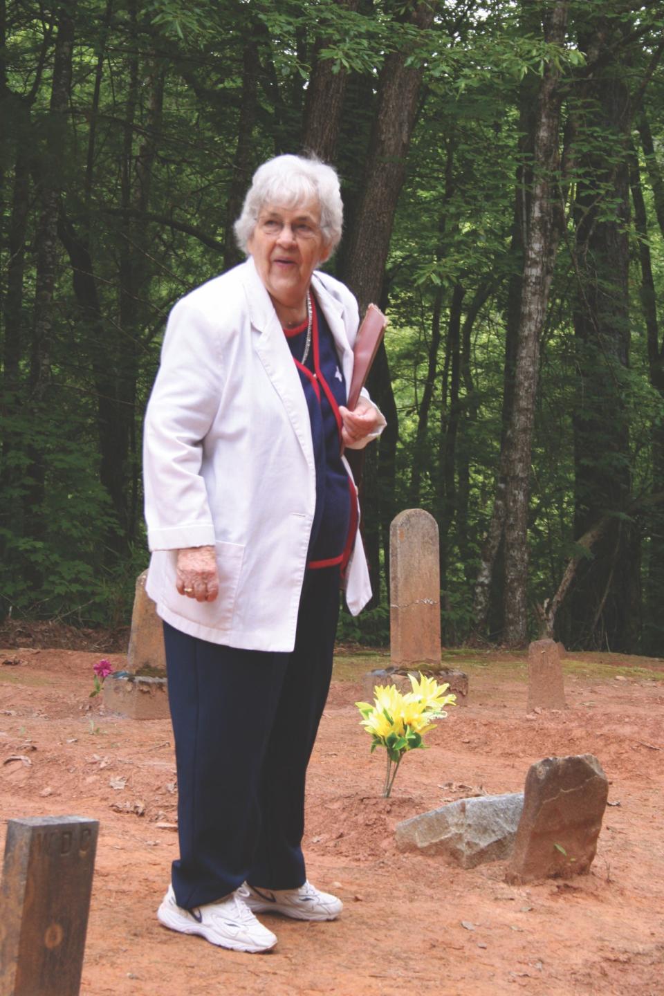 Helen Cable Vance stands in the Cable Cemetery. Vance and her sister Mildred founded the North Shore Cemetery Association in 1976 to help preserve the family histories of the Hazel Creek area.