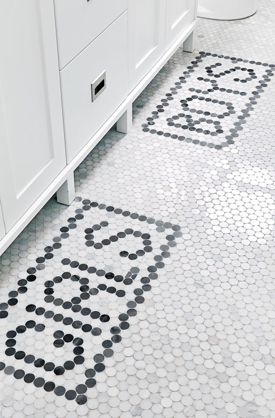 tile typography that spells out girls and boys in bathroom