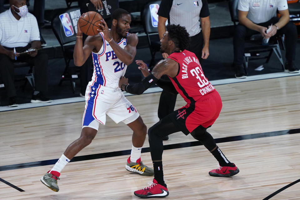 Philadelphia 76ers' Alec Burks (20) drives into Houston Rockets' Robert Covington (33) during the first half of an NBA basketball game Friday, Aug. 14, 2020, in Lake Buena Vista, Fla. (AP Photo/Ashley Landis, Pool)