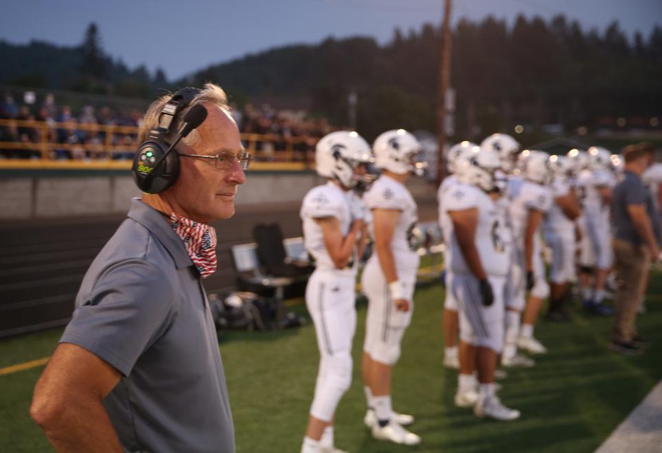 A smile comes across Marist head coach Frank Geske's face as he watches the  the Spartan's game against Sweet Home.