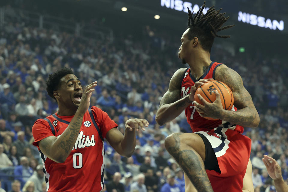 Mississippi's Allen Flanigan, right, pulls down a rebound near his teammate Brandon Murray (0) during the first half of an NCAA college basketball game against Kentucky Tuesday, Feb. 13, 2024, in Lexington, Ky. (AP Photo/James Crisp)