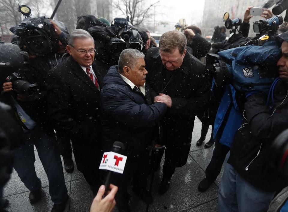 Catalino Guerrero, center, talks to Newark Archbishop Cardinal Joseph Tobin, right, as U.S. Sen. Bob Menendez, left, looks on moments before Guerrero entered the Peter Rodino Federal Building for an immigration hearing, Friday, March 10, 2017, in Newark, N.J. Guerrero, who arrived in the U.S. illegally in 1991, is facing deportation. Organizers claim he is an upstanding citizen and should not be deported. (AP Photo/Julio Cortez)