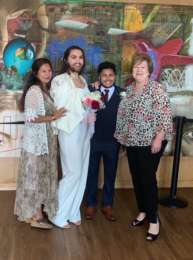 The author at their wedding with their husband, Ethan, their mother (right) and Ethan's mother (left) in 2019.