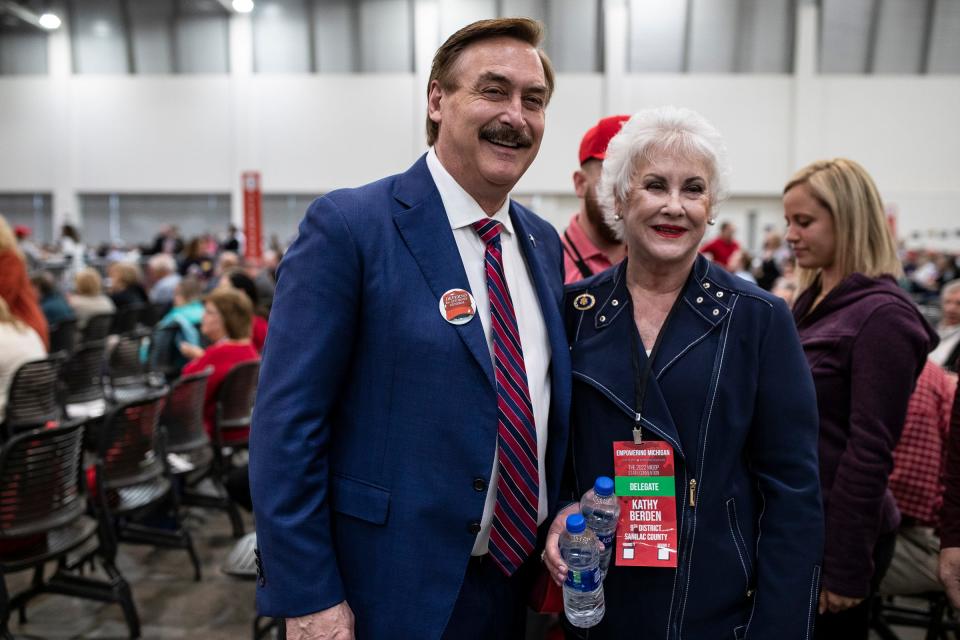 Mike Lindell poses for a photo next to 9th district delegate Kathy Berden during the MIGOP State Convention at the DeVos Place in Grand Rapids on April 23, 2022.