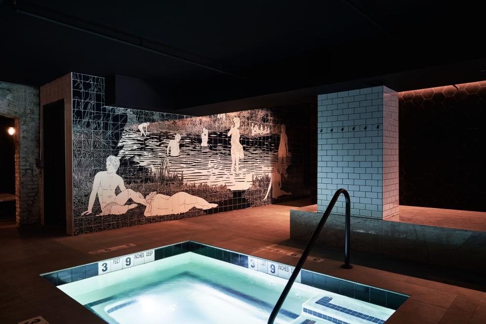 The thermal pool in front of a mural by Amit Greenberg.