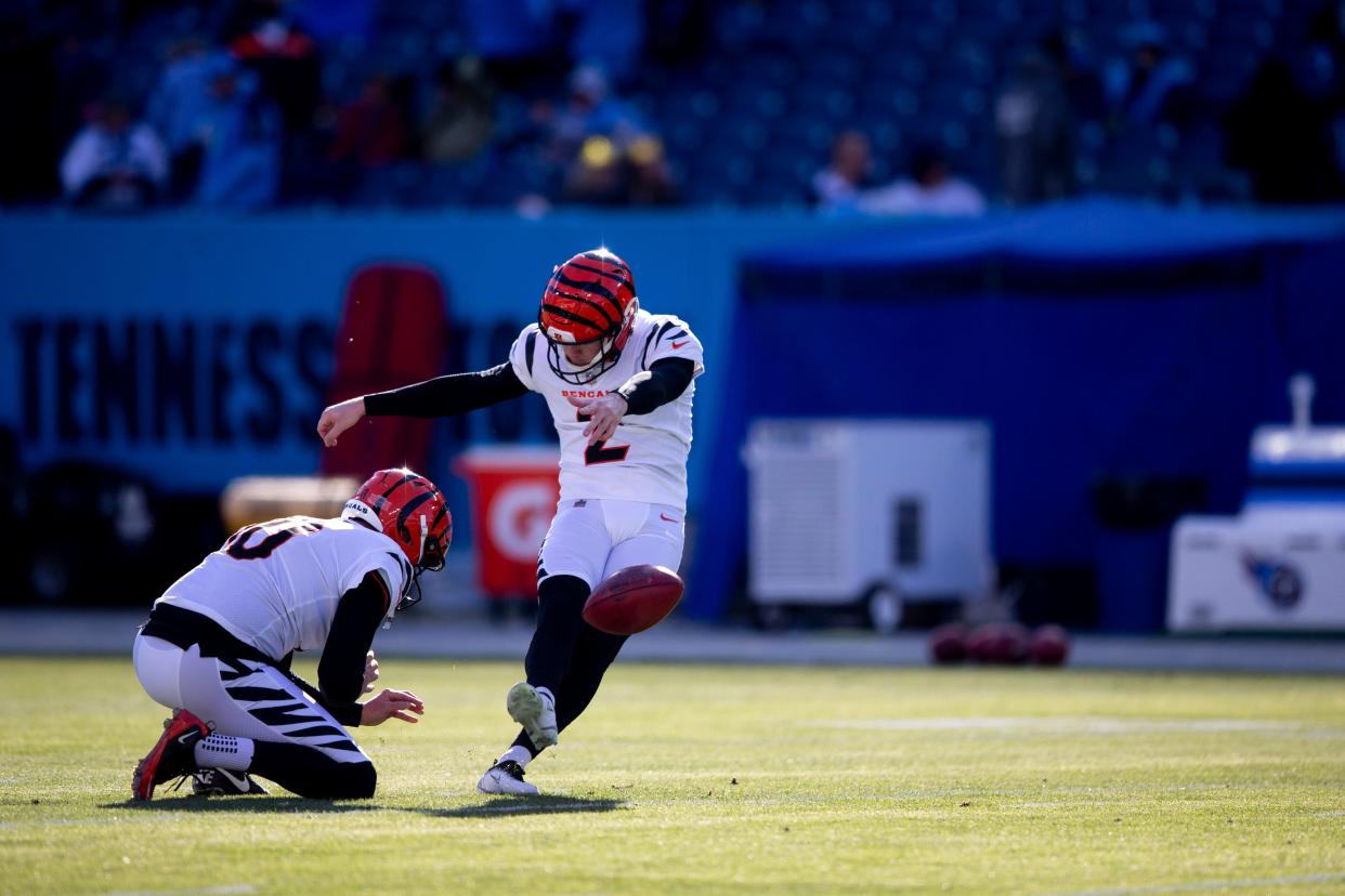 Cincinnati Bengals kicker Evan McPherson (2) practices kicking a field goal as Cincinnati Bengals punter Kevin Huber (10) holds before an NFL divisional playoff football game between the Tennessee Titans and the Cincinnati Bengals, Saturday, Jan. 22, 2022, at Nissan Stadium in Nashville, Tenn.