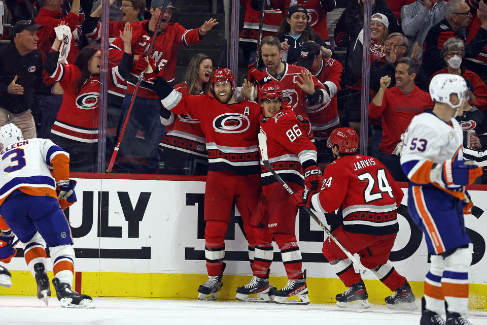 Carolina Hurricanes' Jaccob Slavin is congratulated by Teuvo Teravainen (86) and Seth Jarvis (24) for his goal against the New York Islanders during the second period in Game 2 of an NHL hockey Stanley Cup first-round playoff series in Raleigh, N.C., Wednesday, April 19, 2023. (AP Photo/Karl B DeBlaker)
