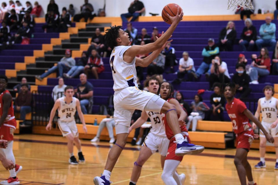 Derrick Evans (4) goes up for a layup to open the scoring for Wylie during Friday's game against Lubbock Coronado. The Bulldogs overcame a slow start to win 50-43.